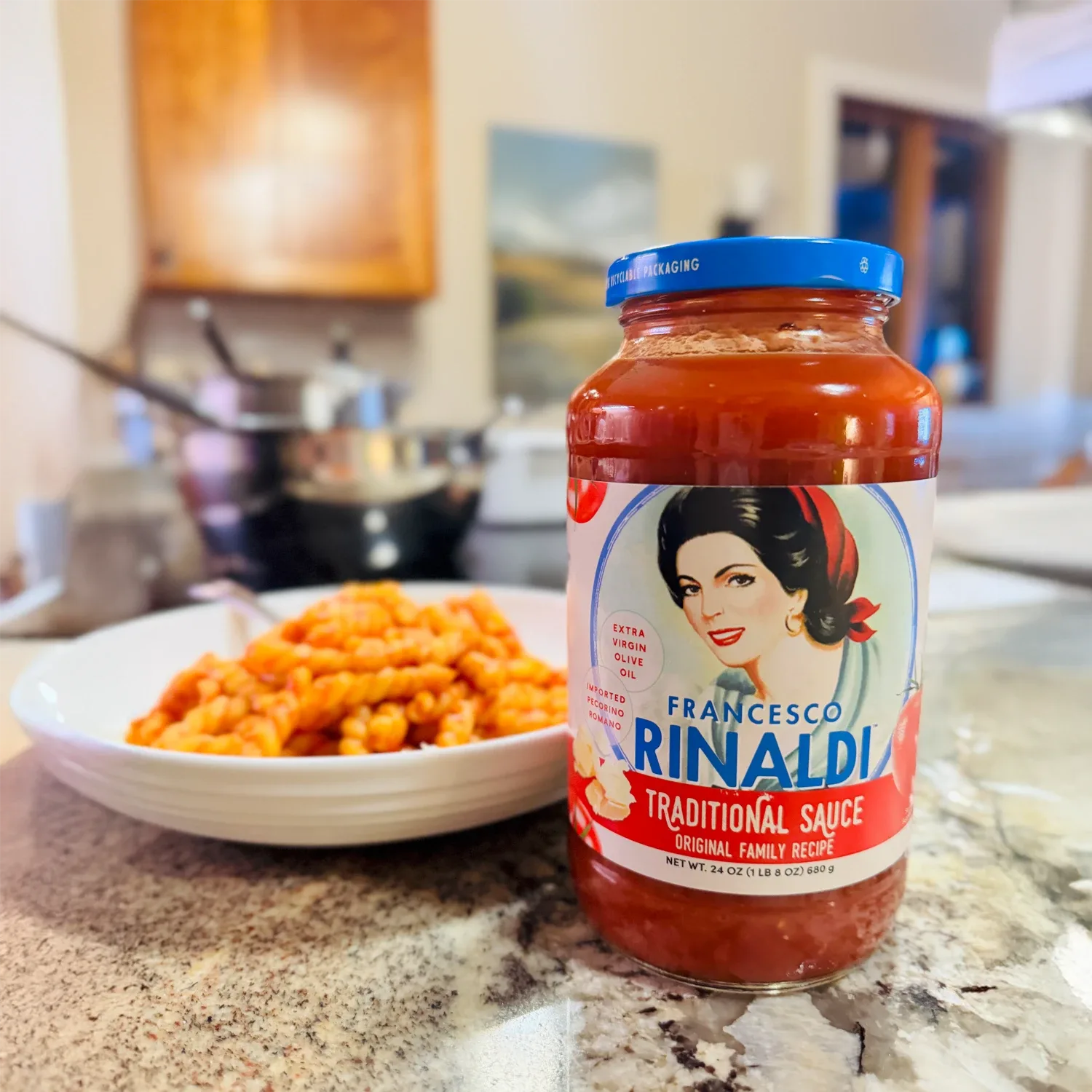 Jar of Francesco Rinaldi Traditional Sauce used in a recipe in a kitchen.