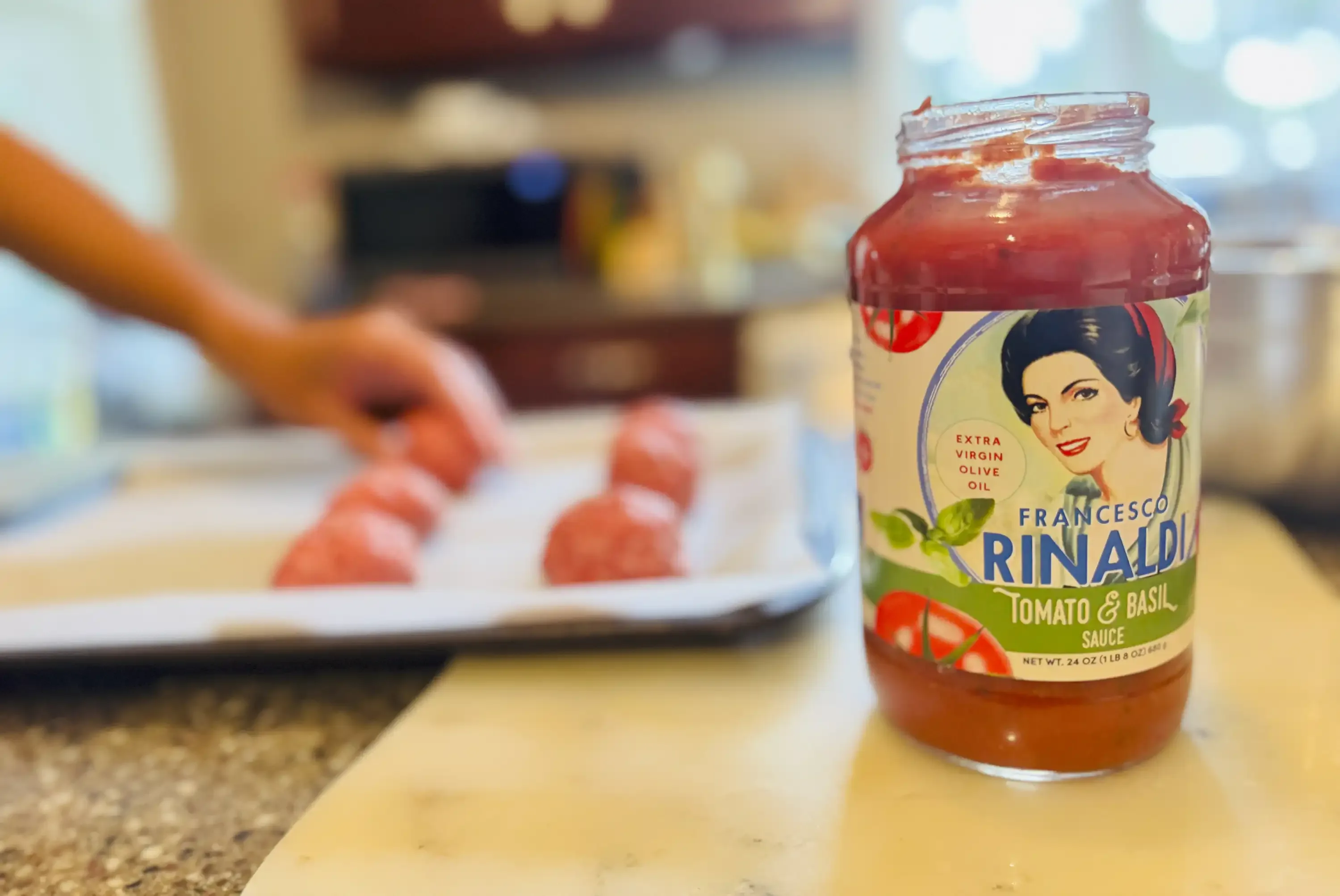 Person shapes meatballs, Francesco Rinaldi Tomato & Basil jar of sauce.